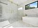 Luxurious bathroom with a glass shower, freestanding tub, and marble tiling at 5175 Cascade Rd, Atlanta, GA 30331