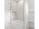 Modern tub and shower featuring decorative tile, recessed lighting, and a built-in shelf at 5175 Cascade Rd, Atlanta, GA 30331