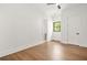 Spacious bedroom with light hardwood floors, fan, and natural light from the window at 5175 Cascade Rd, Atlanta, GA 30331