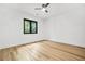Bright bedroom features a ceiling fan, wood floors, and a window with green outdoor view at 5175 Cascade Rd, Atlanta, GA 30331