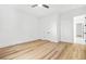 Bedroom with wood floors, white trim, ceiling fan, and a door leading to another room at 5175 Cascade Rd, Atlanta, GA 30331