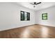 Bright bedroom features hardwood floors, a ceiling fan, and windows with a view at 5175 Cascade Rd, Atlanta, GA 30331