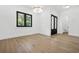 Open bedroom with wood flooring, large windows, and modern lighting at 5175 Cascade Rd, Atlanta, GA 30331