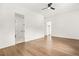 Bright bedroom with hardwood floors and ceiling fan showcasing adjacent rooms at 5175 Cascade Rd, Atlanta, GA 30331