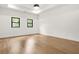 Bright bedroom with a ceiling fan and hardwood floors with black trim windows at 5175 Cascade Rd, Atlanta, GA 30331