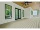 Spacious outdoor deck featuring modern design elements, a ceiling fan, and double doors leading indoors at 5175 Cascade Rd, Atlanta, GA 30331