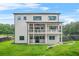 Back exterior view of a two-story house with a spacious yard and multiple decks at 5175 Cascade Rd, Atlanta, GA 30331