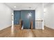 Hallway with wood floors, wood railing, and a decorative blue wall at 5175 Cascade Rd, Atlanta, GA 30331
