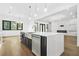 Open-concept kitchen island with stainless steel sink, modern faucet, and view into the living room at 5175 Cascade Rd, Atlanta, GA 30331