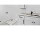 Bright laundry room featuring white cabinets, a countertop, and modern fixtures at 5175 Cascade Rd, Atlanta, GA 30331