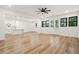 Spacious living room featuring hardwood floors, modern lighting, and kitchen with island at 5175 Cascade Rd, Atlanta, GA 30331