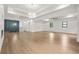 Large living area with hardwood floors, chandelier, and staircase with a wood accent wall at 5175 Cascade Rd, Atlanta, GA 30331