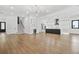 Open-concept living space with hardwood floors, stylish kitchen, and staircase at 5175 Cascade Rd, Atlanta, GA 30331