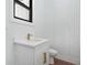 Modern powder room featuring white vanity, gold hardware, and stylish wall accents at 5175 Cascade Rd, Atlanta, GA 30331