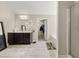 Stylish bathroom with a dark vanity, large mirror, and a view into the walk-in closet and soaking tub at 871 Wisteria View Ct, Dacula, GA 30019