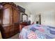 Comfortable bedroom featuring a decorative wardrobe and a colorful quilt on the bed at 871 Wisteria View Ct, Dacula, GA 30019