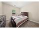 Bedroom with carpeted floors, a window, and a dark wood bed with a patterned bedspread at 871 Wisteria View Ct, Dacula, GA 30019