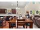 Open dining room with a large table, dark wood cabinets, and natural light at 871 Wisteria View Ct, Dacula, GA 30019