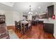 Open dining room and kitchen layout with dark wood cabinets and flooring at 871 Wisteria View Ct, Dacula, GA 30019