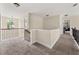 Upstairs hallway with carpet flooring and views of the living spaces below at 871 Wisteria View Ct, Dacula, GA 30019