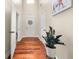 Hallway featuring hardwood floors and white doors, with a decorative plant and elephant art print at 871 Wisteria View Ct, Dacula, GA 30019