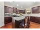 Well-equipped kitchen with granite countertops, dark cabinets, and a kitchen island at 871 Wisteria View Ct, Dacula, GA 30019
