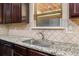 Close up of the kitchen sink with granite countertops and tile backsplash at 871 Wisteria View Ct, Dacula, GA 30019