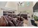 Open-concept living room with hardwood floors, a vaulted ceiling, and comfortable leather sofas at 871 Wisteria View Ct, Dacula, GA 30019