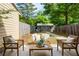 Secluded backyard patio, fenced-in yard, with lush landscaping, seating and shed at 1092 Old Roswell Rd, Roswell, GA 30076