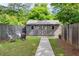 Secluded backyard shed, fenced-in yard, with lush landscaping, and fire pit at 1092 Old Roswell Rd, Roswell, GA 30076