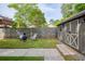 Backyard featuring a storage shed, fireplace, seating area, and grassy lawn, perfect for outdoor gatherings at 1092 Old Roswell Rd, Roswell, GA 30076