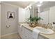 Bright bathroom featuring a double sink vanity, neutral countertops, white cabinets, and modern finishes at 1092 Old Roswell Rd, Roswell, GA 30076