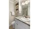 A bathroom with a granite countertop vanity, white cabinetry, modern fixtures, and a glass-enclosed shower at 1092 Old Roswell Rd, Roswell, GA 30076
