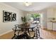 Dining area featuring hardwood floors, modern art, french doors to the patio, and a round dining table at 1092 Old Roswell Rd, Roswell, GA 30076