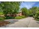 Long driveway leading to a beautiful brick house with mature landscaping and plenty of trees at 1092 Old Roswell Rd, Roswell, GA 30076