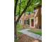 Charming brick home featuring a red front door with a wreath and a well-manicured lawn at 1092 Old Roswell Rd, Roswell, GA 30076
