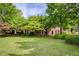 Two-story brick house featuring lush lawn, mature trees, and manicured shrubbery at 1092 Old Roswell Rd, Roswell, GA 30076