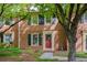 Charming brick home featuring a red front door and a well-manicured lawn at 1092 Old Roswell Rd, Roswell, GA 30076