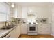 Charming kitchen featuring white cabinets, granite countertops, and a window at 1092 Old Roswell Rd, Roswell, GA 30076