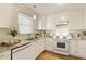 Charming kitchen featuring white cabinets, granite countertops and tile backsplash at 1092 Old Roswell Rd, Roswell, GA 30076