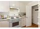 Bright kitchen with granite countertops, white appliances, and pantry shelves at 1092 Old Roswell Rd, Roswell, GA 30076