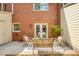 Rear patio area features a cushioned bench, a bistro set, with access to the main home at 1092 Old Roswell Rd, Roswell, GA 30076
