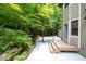 Back of house with patio and landscaped yard with mature trees at 1560 Bubbling Creek Ne Rd, Atlanta, GA 30319