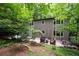 Charming two-story home with a spacious wooden deck and lush, mature landscaping surrounded by trees at 1560 Bubbling Creek Ne Rd, Atlanta, GA 30319