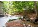 Backyard area with gravel and mulch and many trees and landscaping elements at 1560 Bubbling Creek Ne Rd, Atlanta, GA 30319