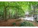 The beautiful backyard is surrounded by mature trees and lush landscaping, perfect for outdoor enjoyment at 1560 Bubbling Creek Ne Rd, Atlanta, GA 30319