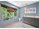 Modern bathroom with a double vanity sink, a large illuminated mirror, and an attractive window view at 1560 Bubbling Creek Ne Rd, Atlanta, GA 30319