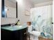 Bathroom featuring vanity with frosted glass countertop and a tropical-themed shower curtain at 1560 Bubbling Creek Ne Rd, Atlanta, GA 30319