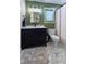 Modern bathroom featuring a stylish vanity with a dark cabinet, new fixtures, and lovely hexagon tile floor at 1560 Bubbling Creek Ne Rd, Atlanta, GA 30319
