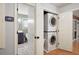 A laundry closet is adjacent to a modern bathroom with dark cabinets, new fixtures, and hexagon tile floor at 1560 Bubbling Creek Ne Rd, Atlanta, GA 30319
